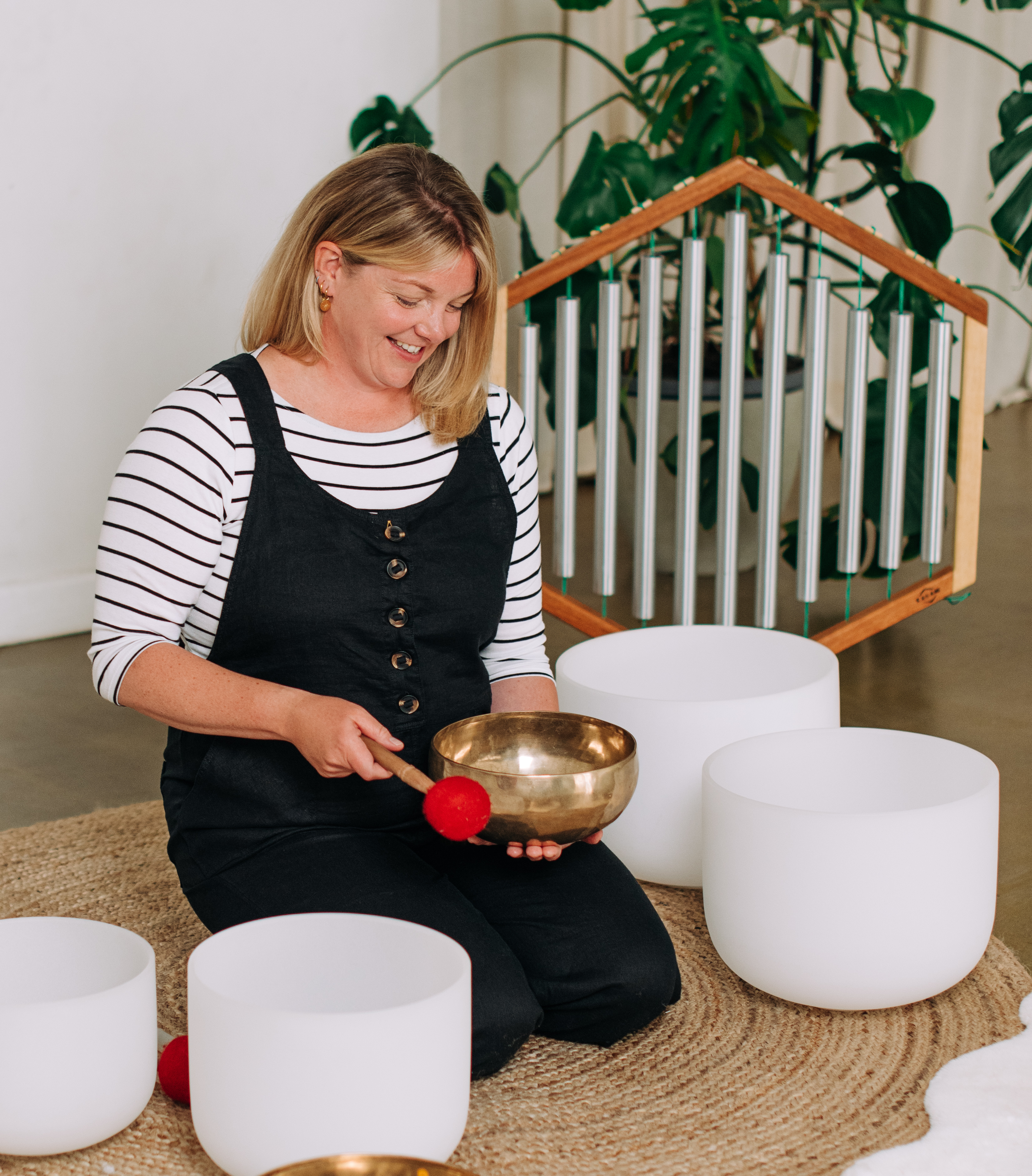 sound healer with crystal bowls and gongs